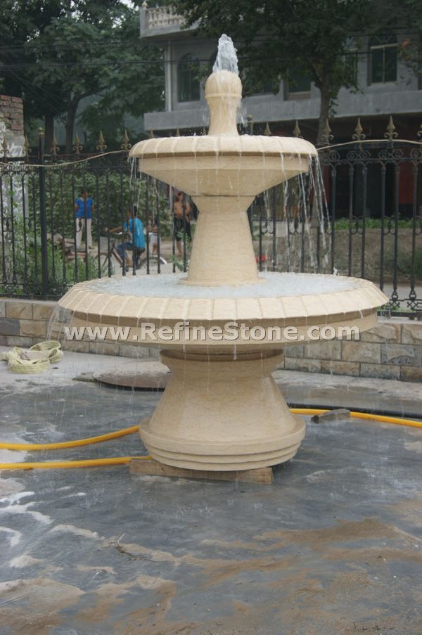 beige marble water fountain sculpture